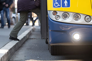 man getting on public transport with disabled badge