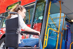 Diasabled person getting on a bus