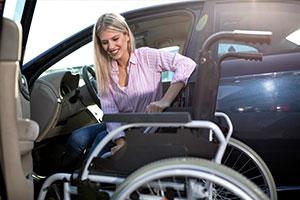 Lady getting out of Motability scheme car